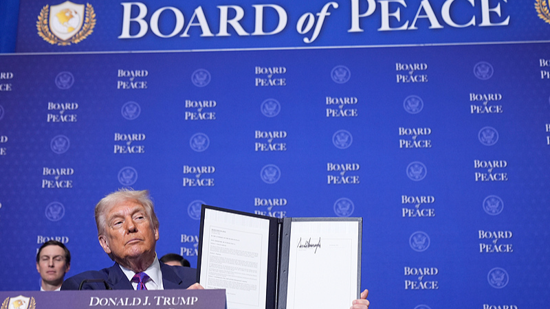 US President Donald Trump holds up a signed resolution during a Board of Peace meeting at the US Institute of Peace, Washington, D.C., February 19, 2026. /CFP